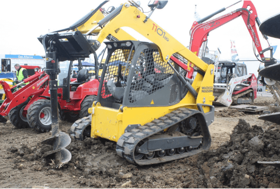 an image of an auger attached to a skid steer loader